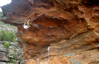 Malcolm Matheson (aka HB) climbing his new roof climb at Sentinel Cave.