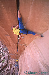 John Varco giving his all on the extremely awkward off-width crack, Belly Full of Bad Berries (5.13ba/b), Indian Creek, Utah, USA.