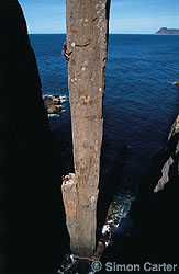 Simon Mentz leading pitch two of The Free Route (25) on the 65-metre Totem Pole at Cape Hauy, Tasman Peninsula, Tasmania, Australia.