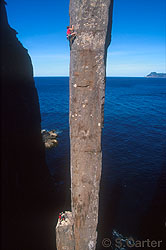 Simon Mentz leading pitch two of The Free Route (25) on the 65-metre Totem Pole at Cape Hauy, Tasman Peninsula, Tasmania, Australia.