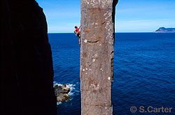 Simon Mentz leading pitch two of The Free Route (25) on the 65-metre Totem Pole at Cape Hauy, Tasman Peninsula, Tasmania, Australia.