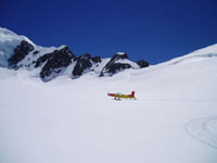 Porter Ski Plane landing on Grand Plateau with Mt Dixon Ridge in the background.