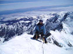 John Kazanas on the summit of Mt Cook with the West Coast behind him